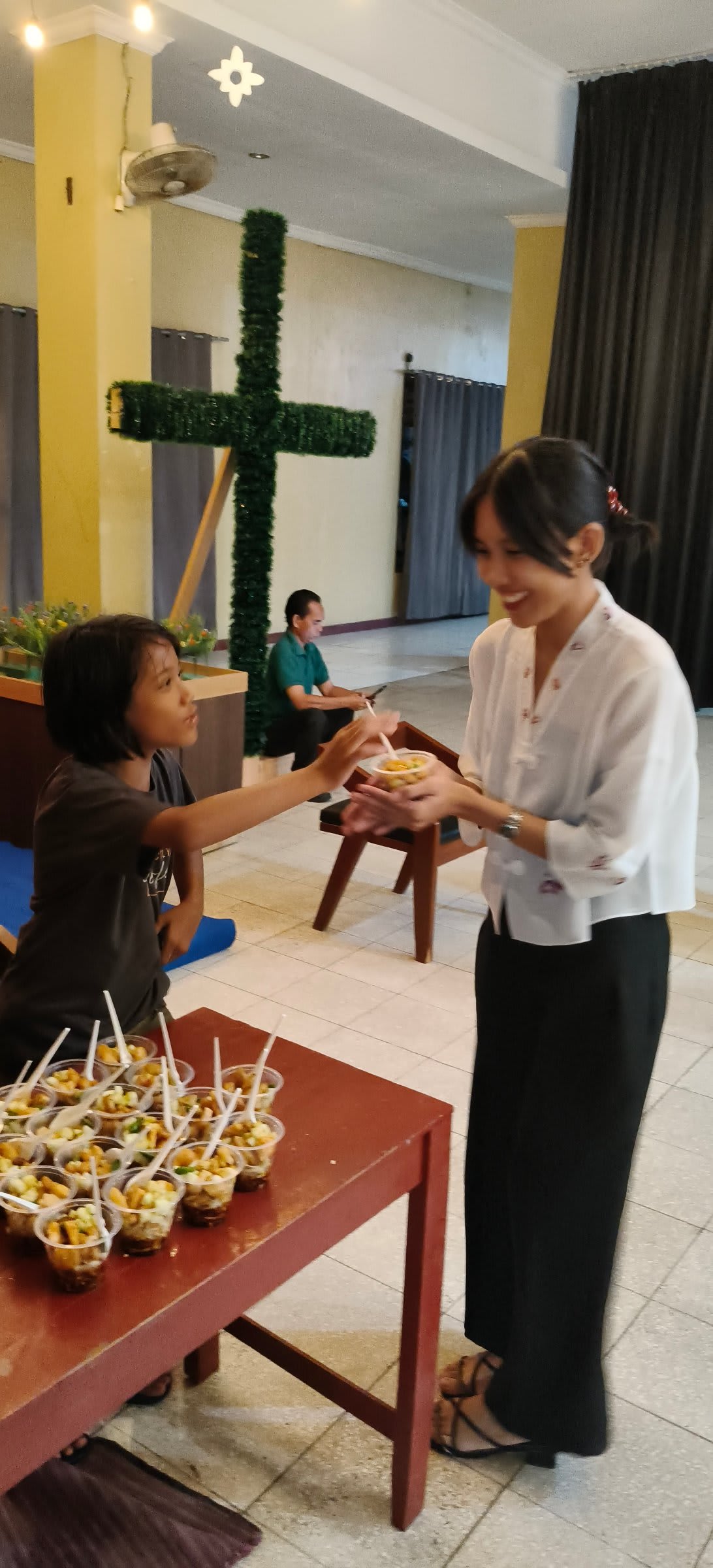 Volunteer serving food to a child at Solo campus Futures Church kids ministry
