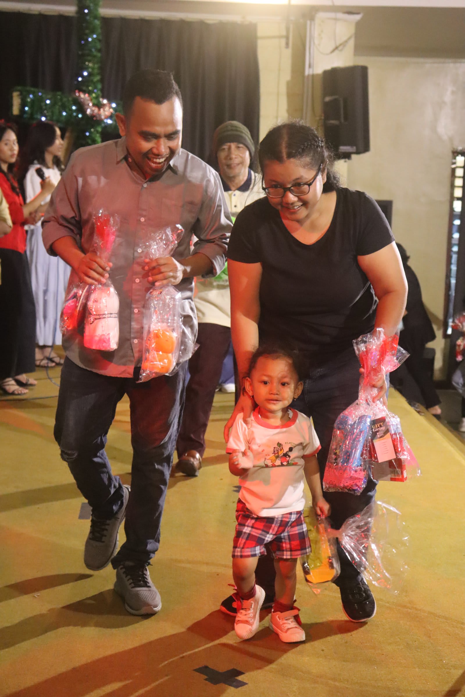 Child receiving Christmas gift at Solo campus Futures Church kids ministry event