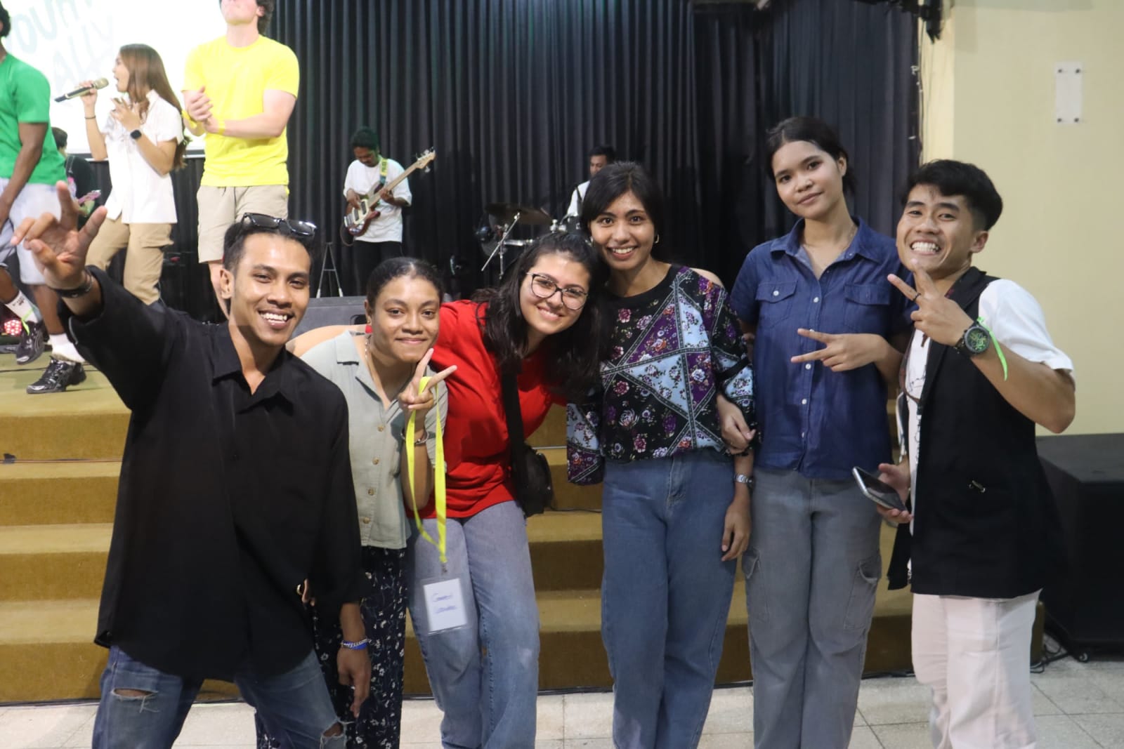 Young adults smiling together at Solo campus Sunday service