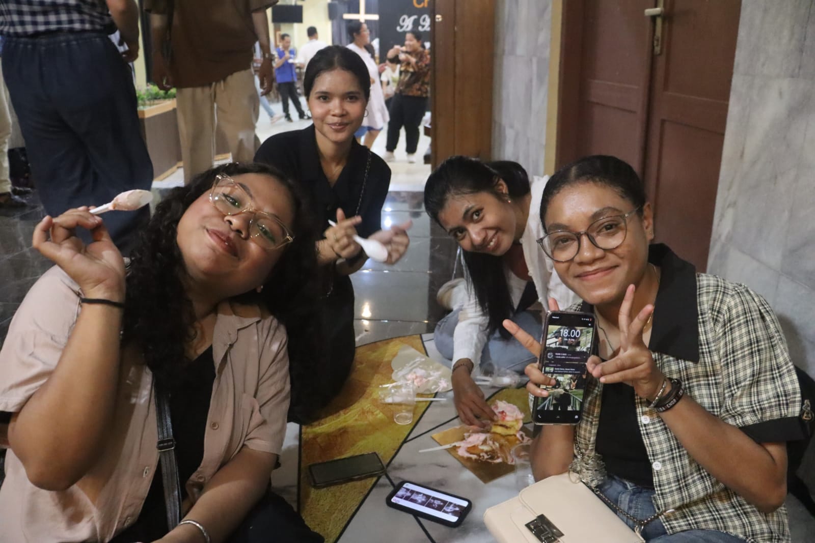 Young women laughing and taking selfie at Solo campus girls community event