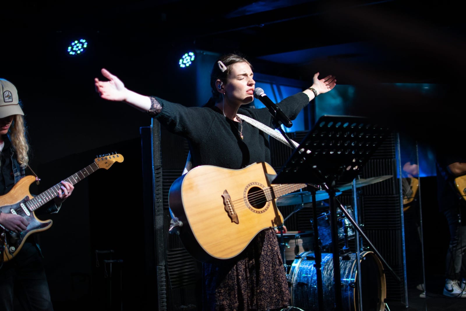 A worship leader singing with arms raised / victor harbor