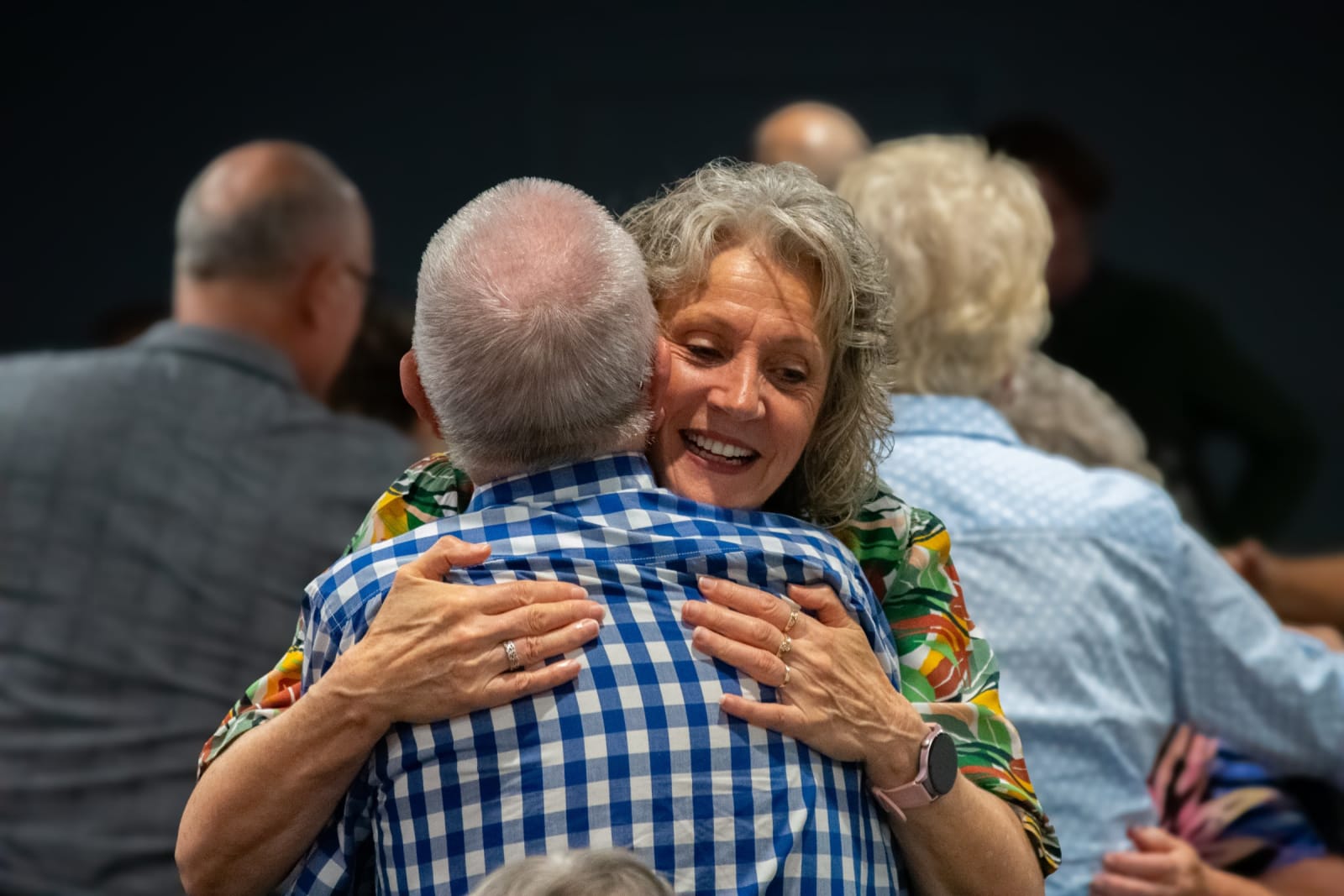 People sharing a joyful hug at a gathering / victor harbor