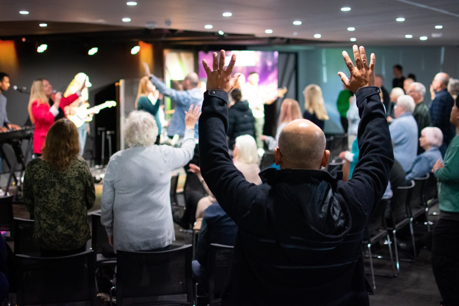 A congregation worshipping with hands raised / victor harbor