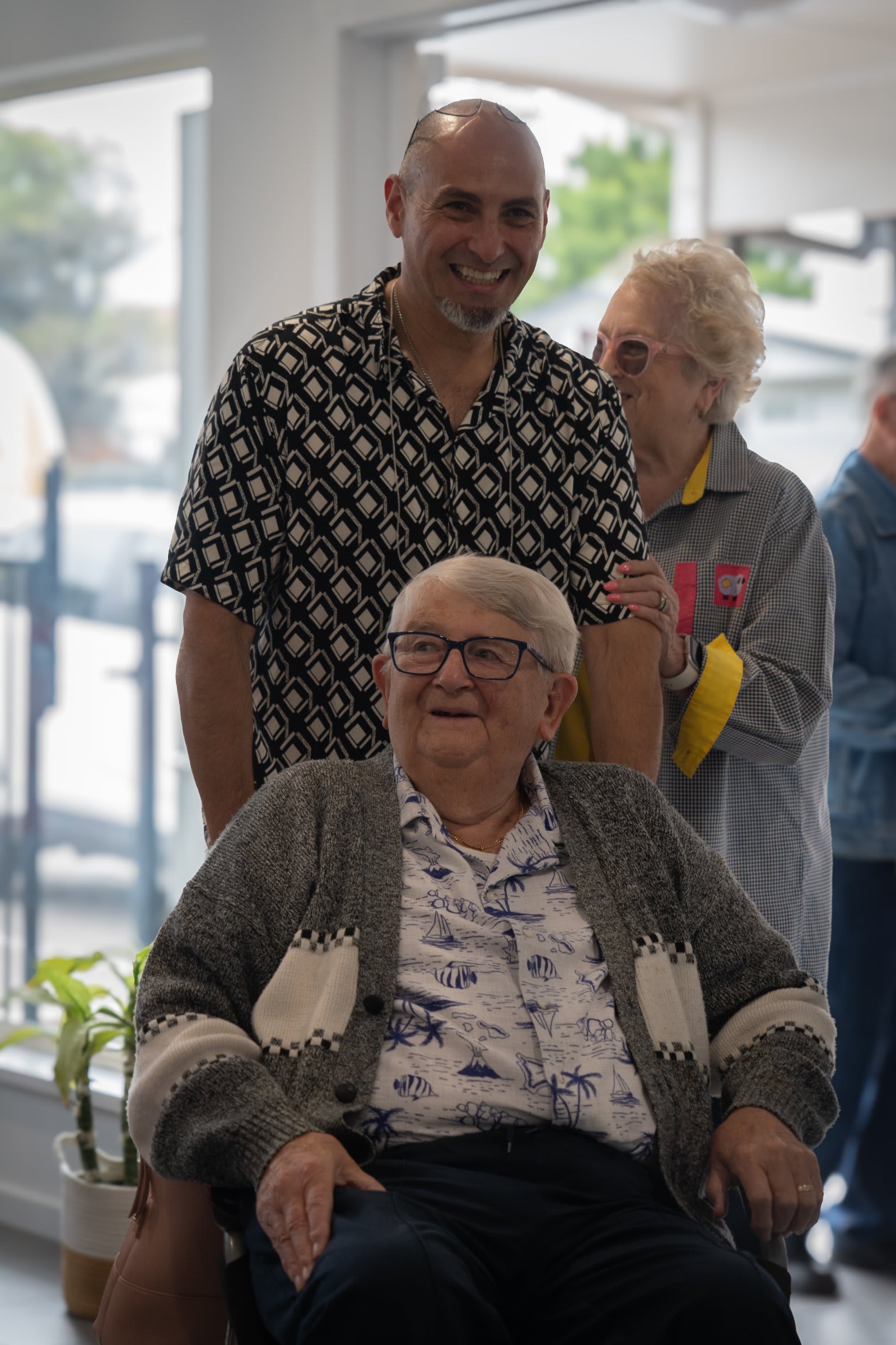 A smiling elderly woman surrounded by friends / victor harbor