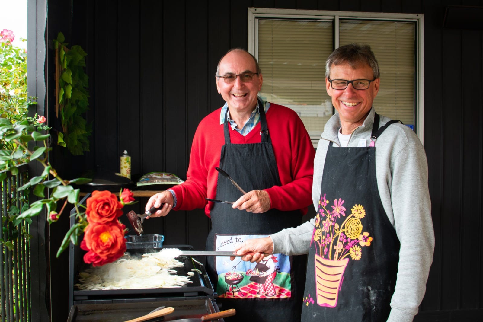 Two men cooking together at a barbecue / victor harbor