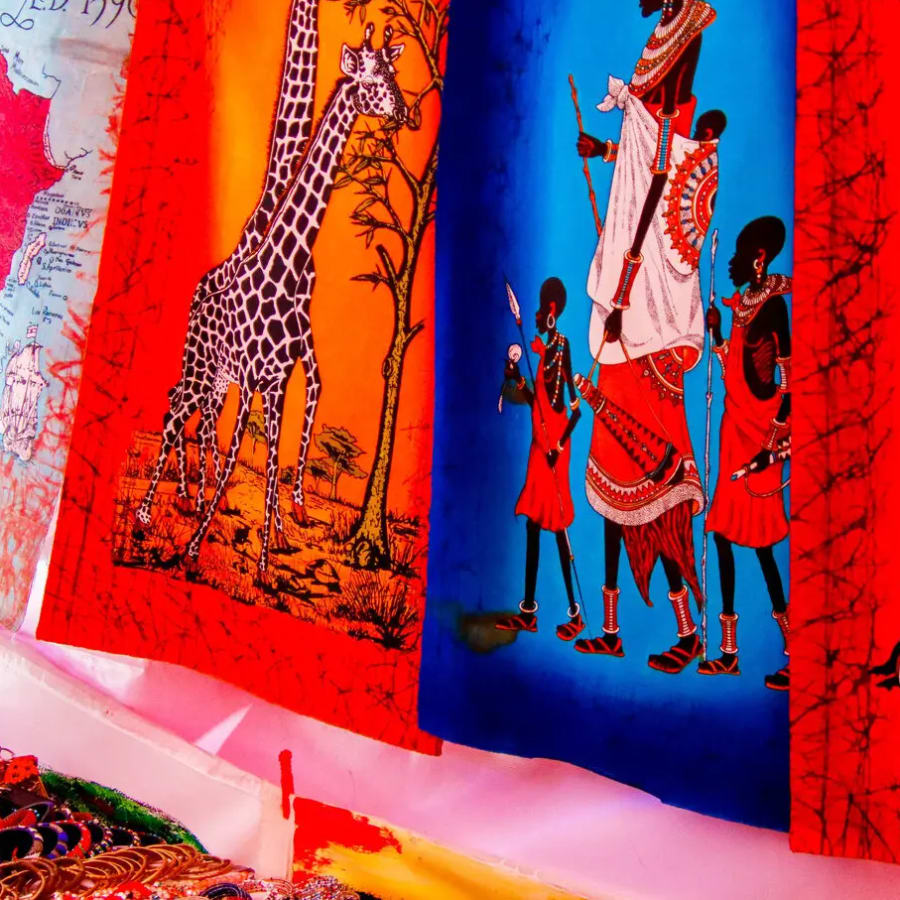 Paintings depicting various african themes, including a map of Africa, giraffes, and figures dressed in traditional clothing., photo 1