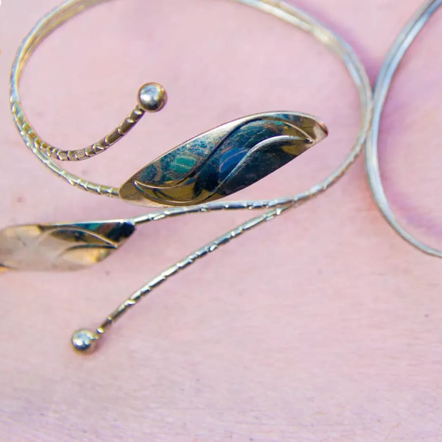 A pair of silver-plated cuff bracelets with a hammered leaf design., photo 1