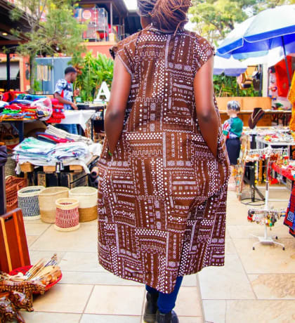 A shopper walking between market stalls