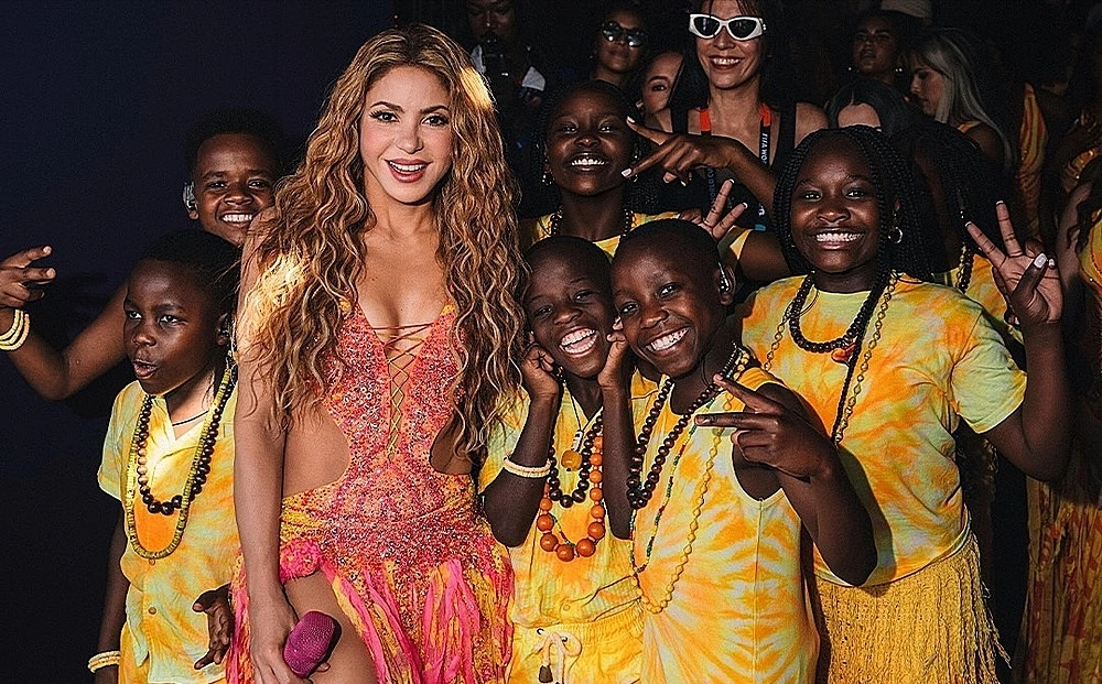 Young dancers celebrating backstage after a major international performance