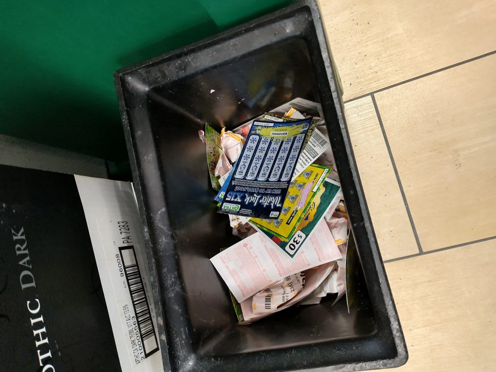 Discarded lottery tickets in the trash at my local 7-Eleven.