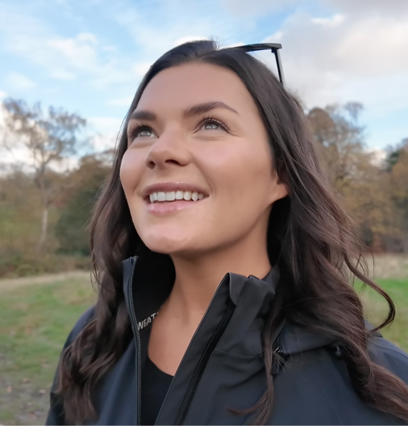 Dani Rayner smiling outdoors in the countryside