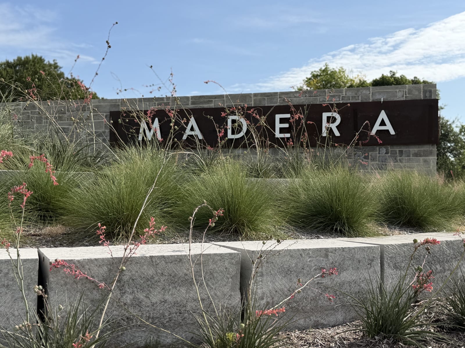 Stone and steel Madera entry monument with landscaped stone block planters in Royse City, TX
