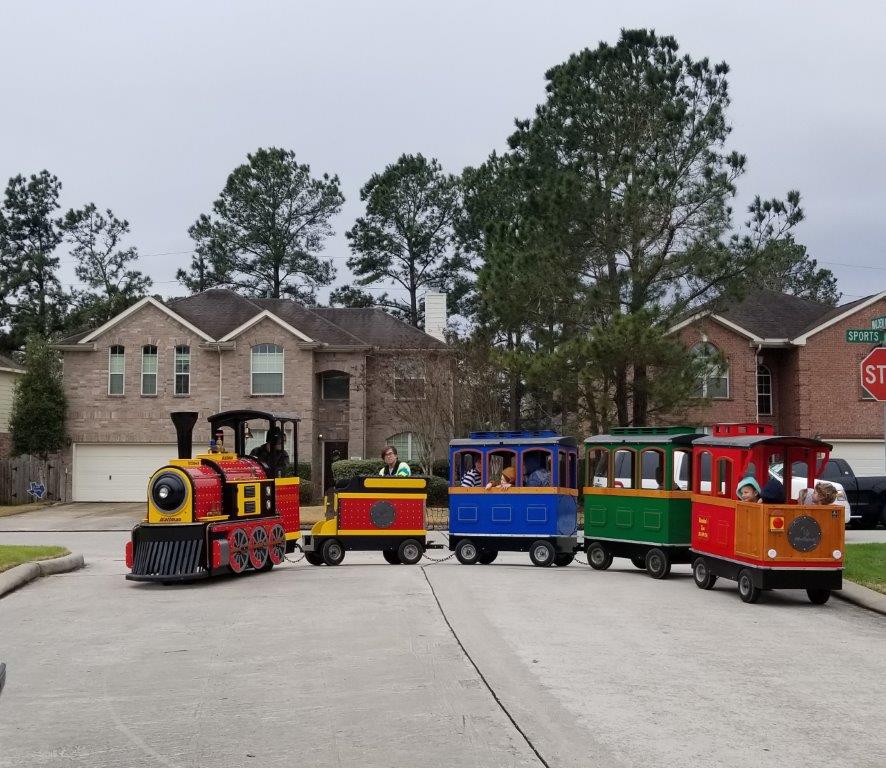 Children enjoying a ride aboard the Texas Flyer trackless train