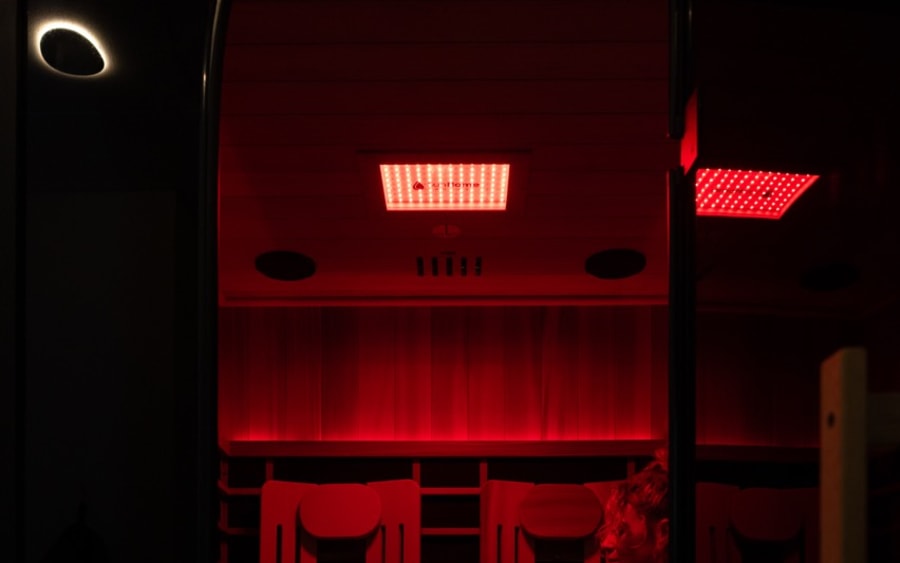 Guest seated in the infrared sauna under red light