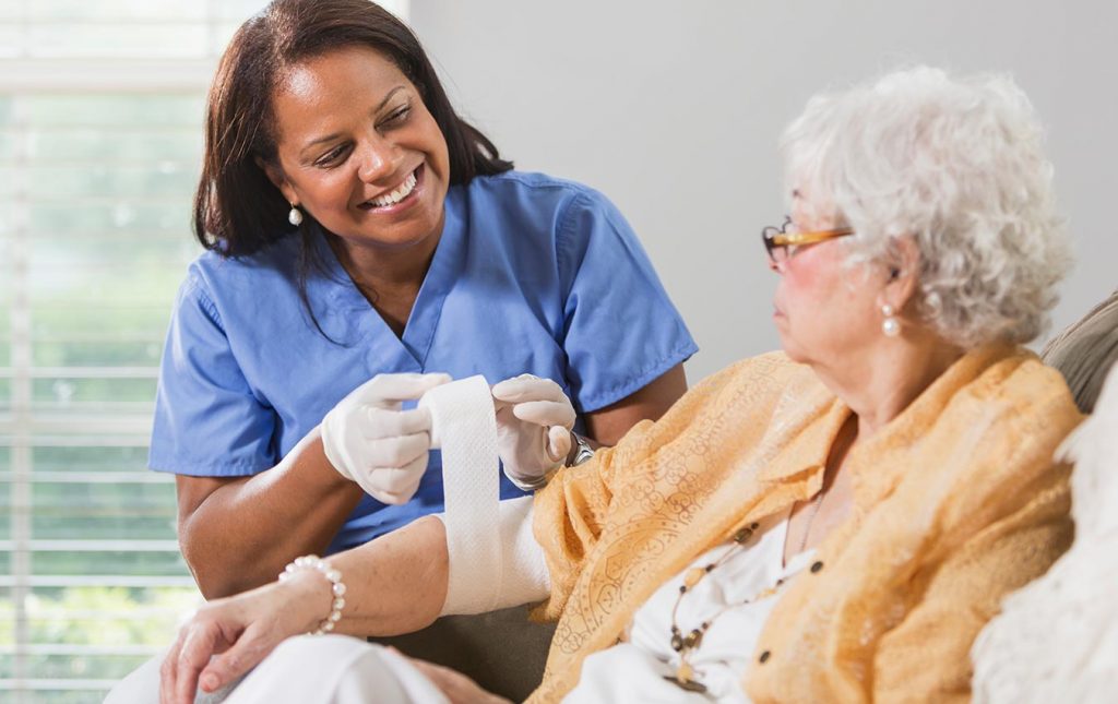 Wound care clinician supporting a patient