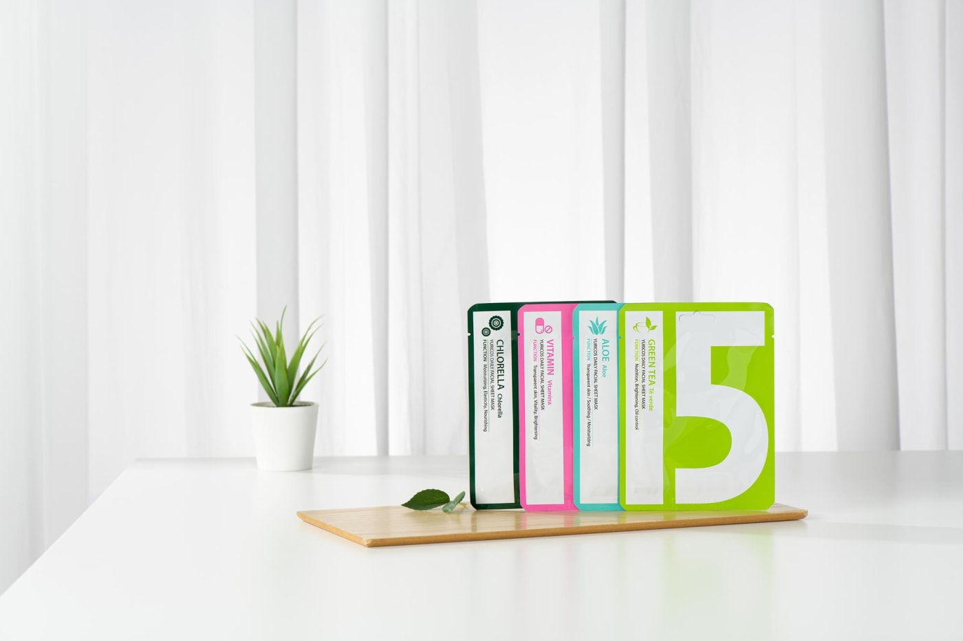 Various types of YURICO5 sheet masks neatly displayed in a living room