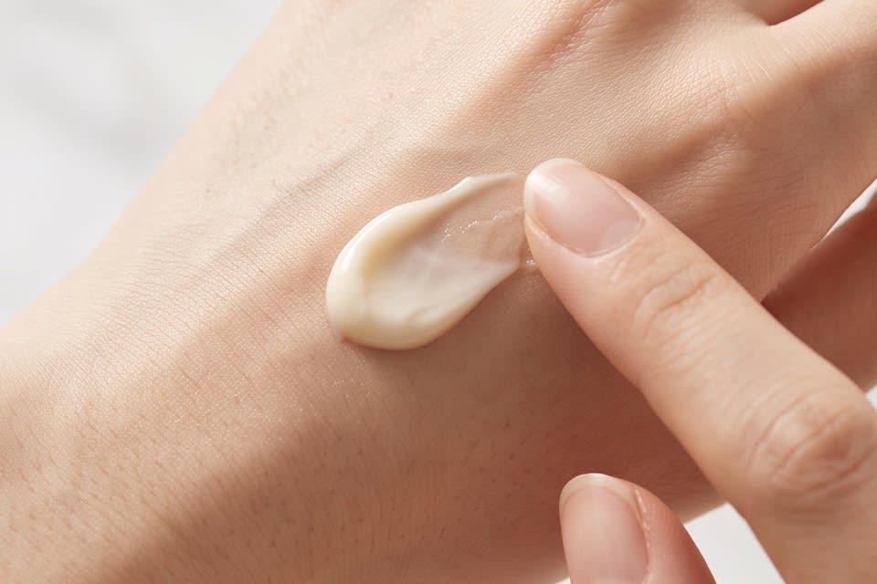 Applying a soft textured cream onto the back of the hand