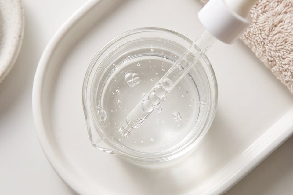 Essence in a transparent container with a dropper