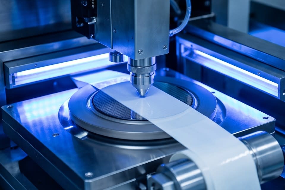 An automated system precisely attaching tape onto a wafer
