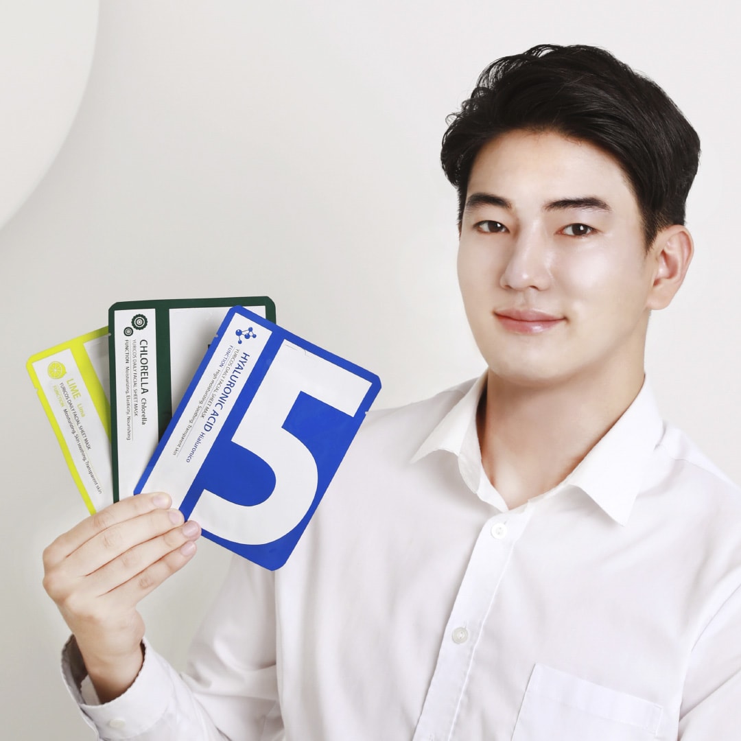 A person holding a sheet mask to choose one that suits their skin condition