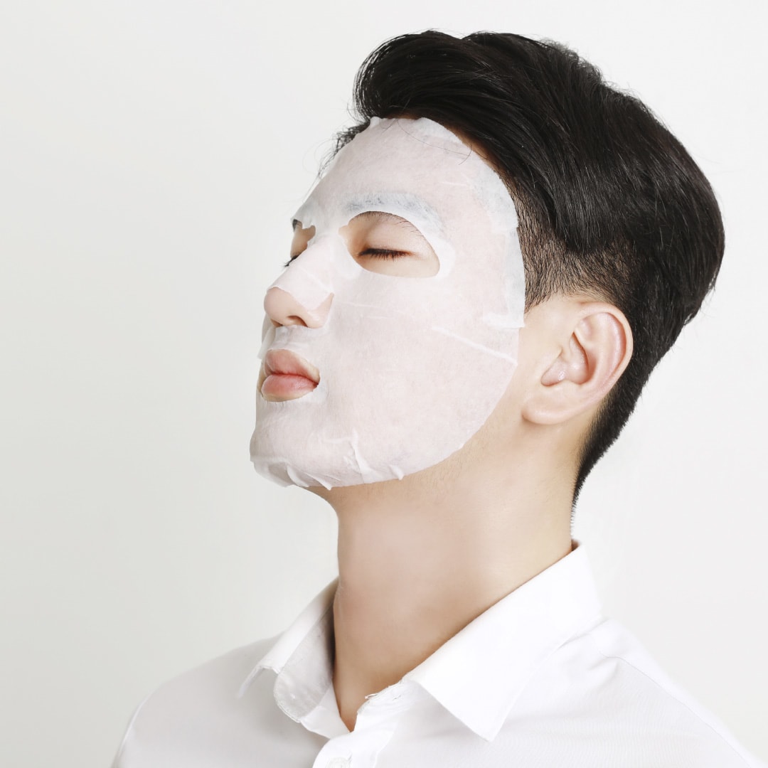A person relaxing with a sheet mask on the face, showing the principle of occlusion