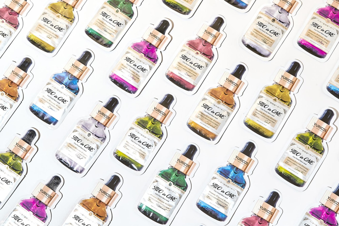 An array of mask pack packages shaped like ampoule bottles in various colors
