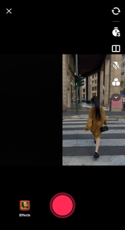 The image show a black screen on one side and on the right side it show a woman from the back walking on a street. On the right corner there is the edit menu from TikTok.