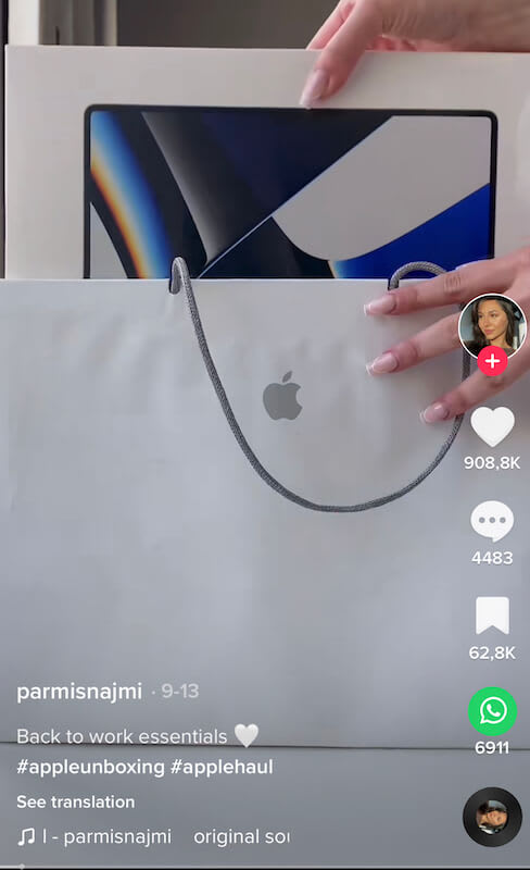 Someone takin an apple product box from a bag.