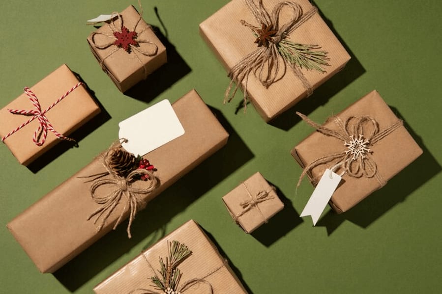 The image shows seven gift boxes wrapped in brown paper.