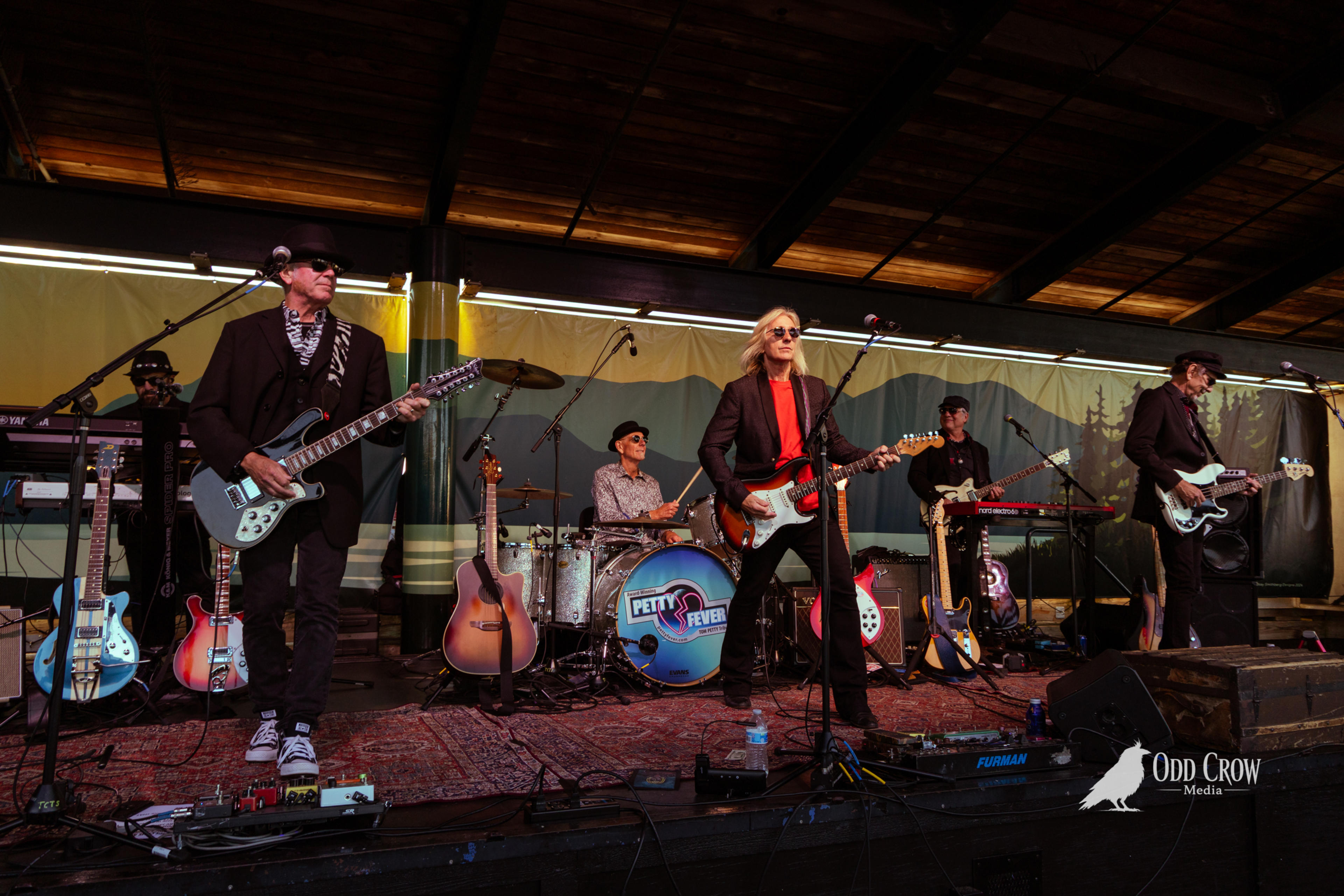 Petty Fever tribute band performing full stage shot at Concerts on the Pier in Port Angeles, Washington with Olympic Mountains visible in the background