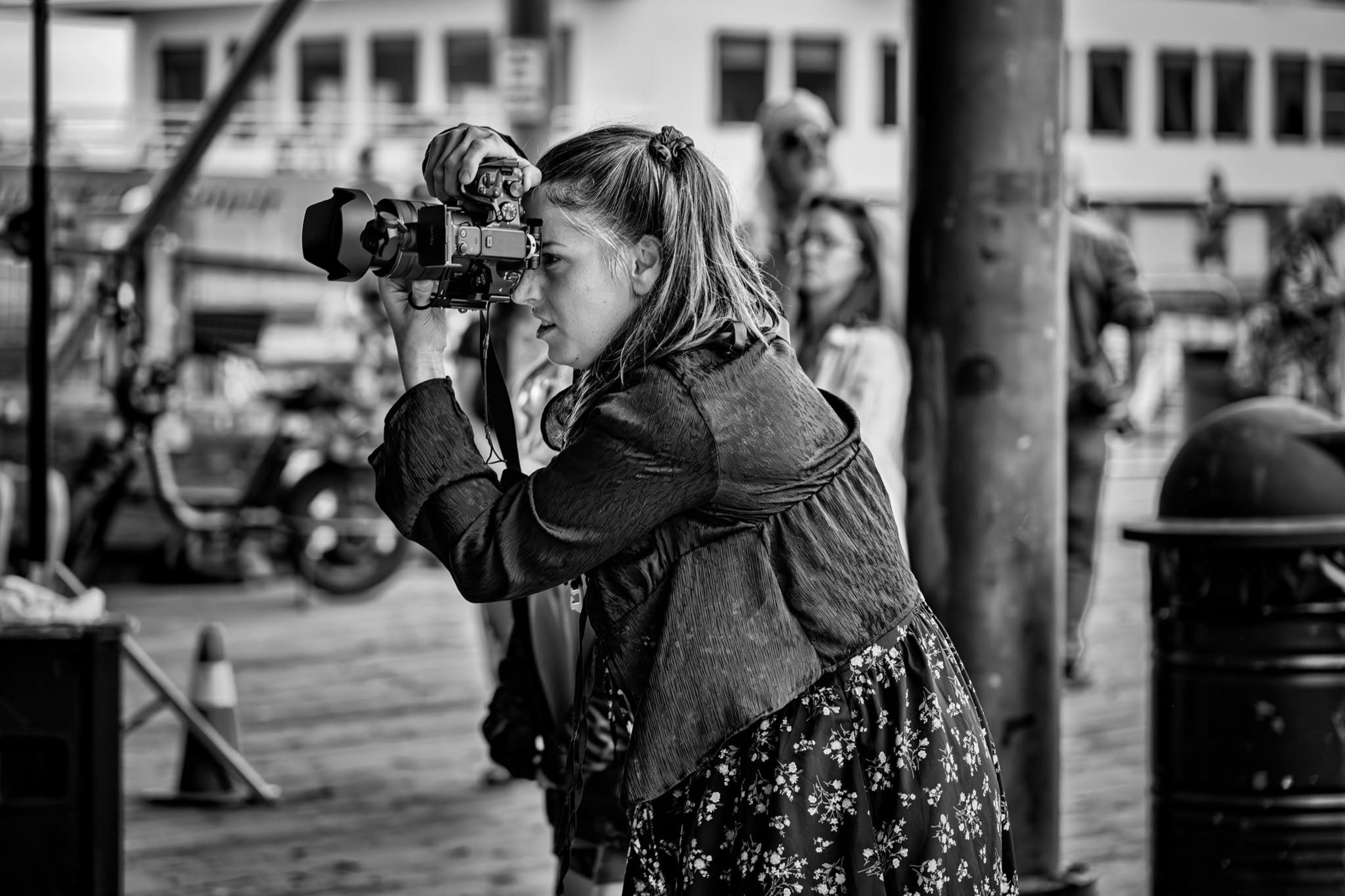 Alaina shooting upright on a pier