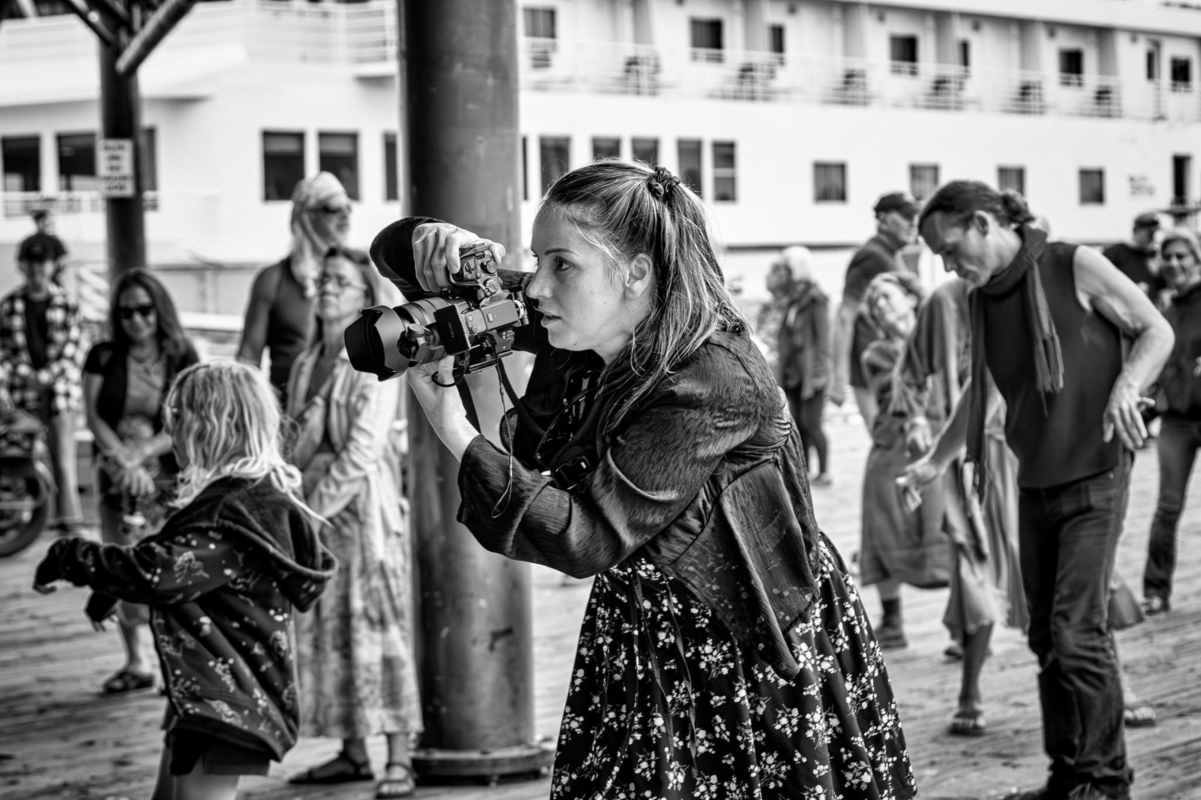 Alaina shooting a crowd session on a pier