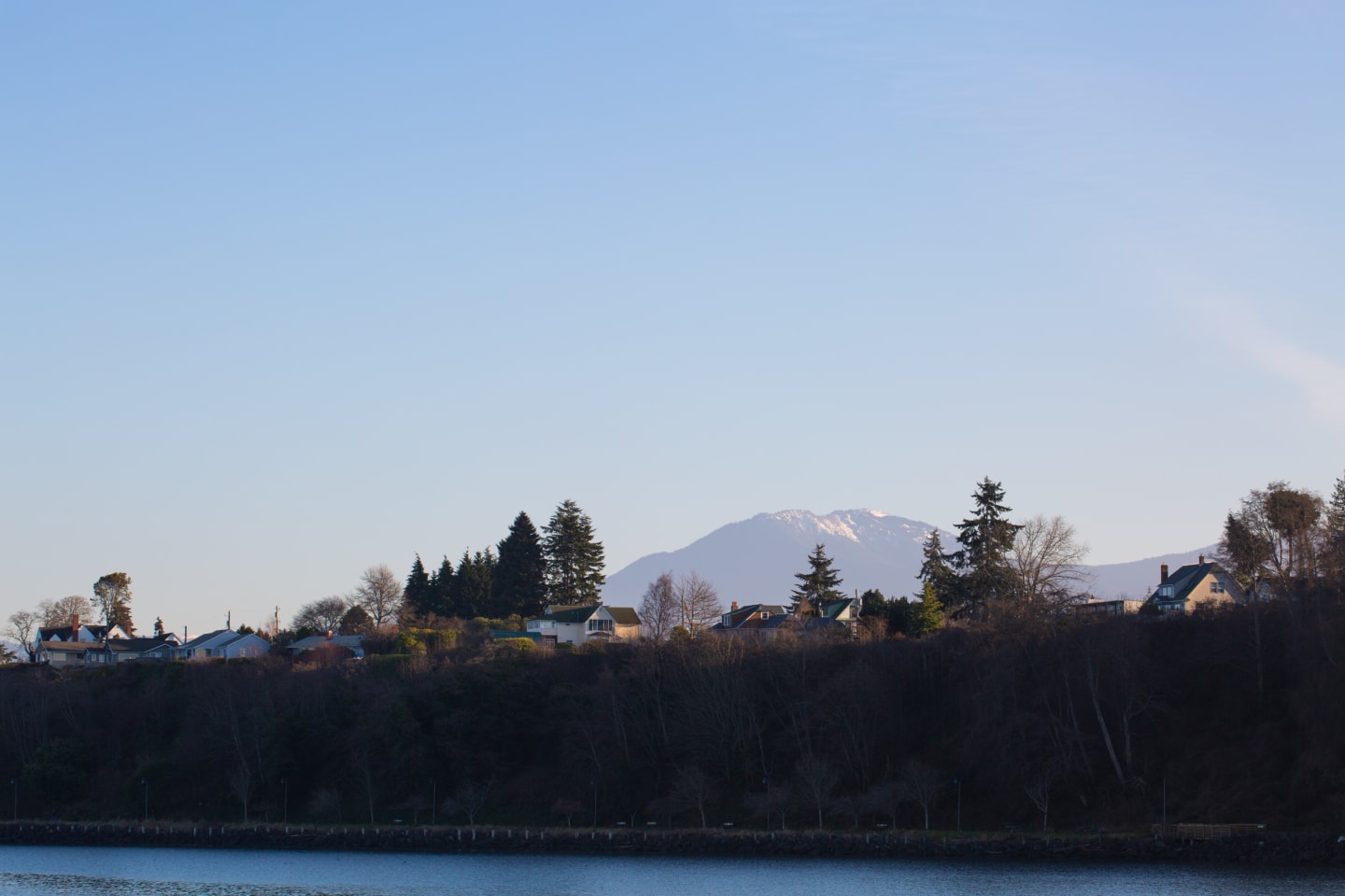 Port Angeles waterfront homes with snow-capped Mount Baker in background across the Strait
