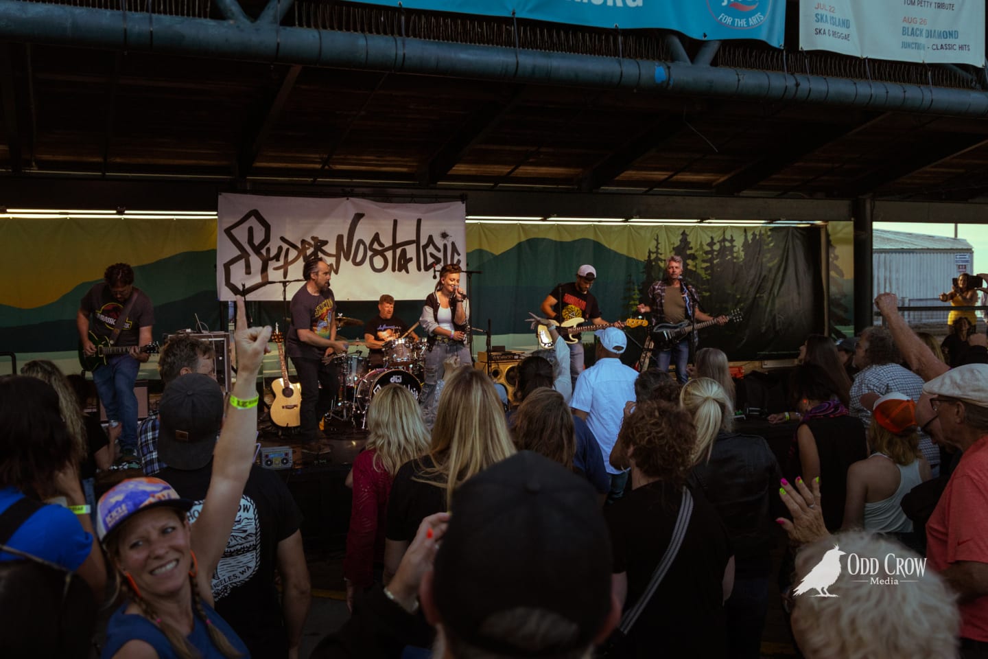 SuperNostalgic band mid-song on the Concerts on the Pier stage, full lineup visible