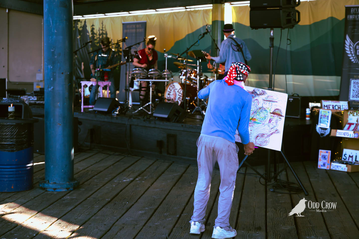 Wide shot of the sparse, relaxed crowd at Day of Play Festival on the Port Angeles pier, camp chairs spread out