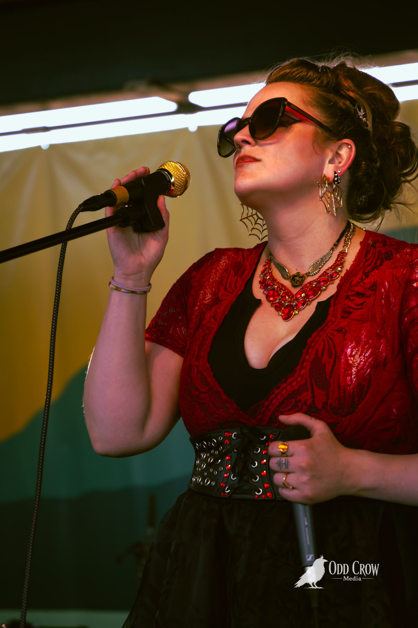 Reckless Dove singer Bee Smith performing in a red lace top and studded corset belt at Day of Play Festival