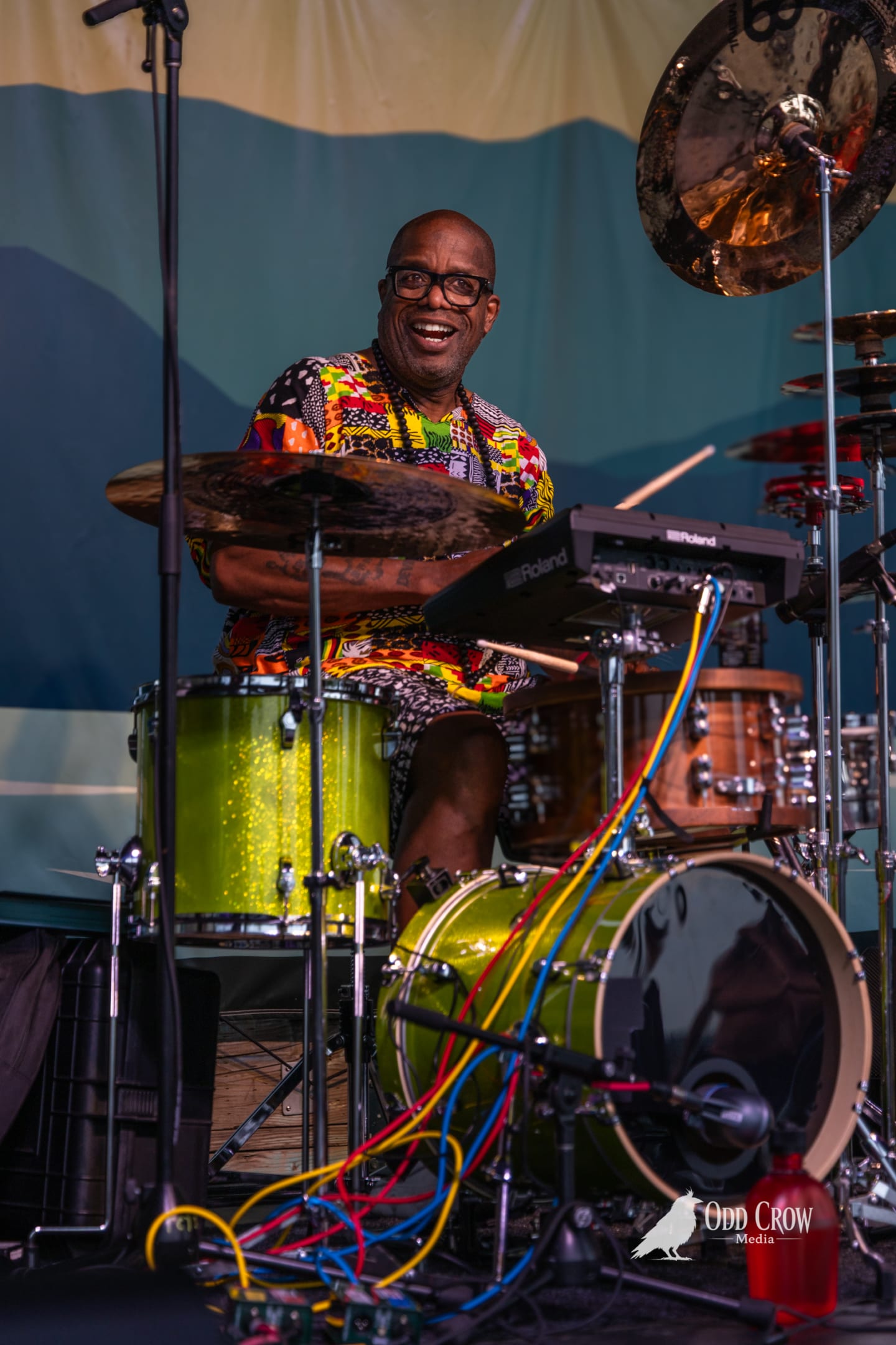 Ska Island drummer behind a bright green drum kit on stage at Concerts on the Pier