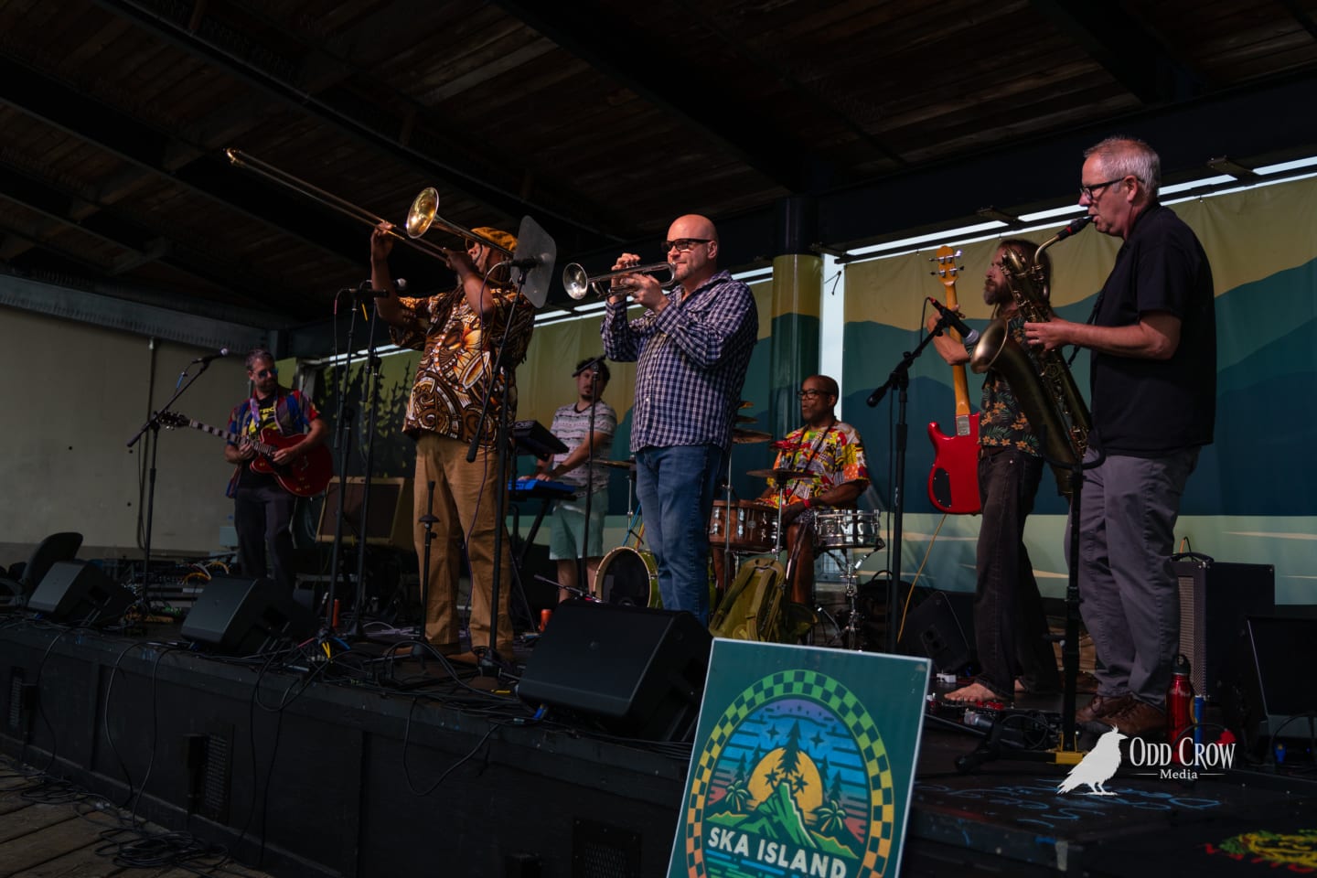 Ska band performs on outdoor stage at Ska Island festival, horn section front and center.