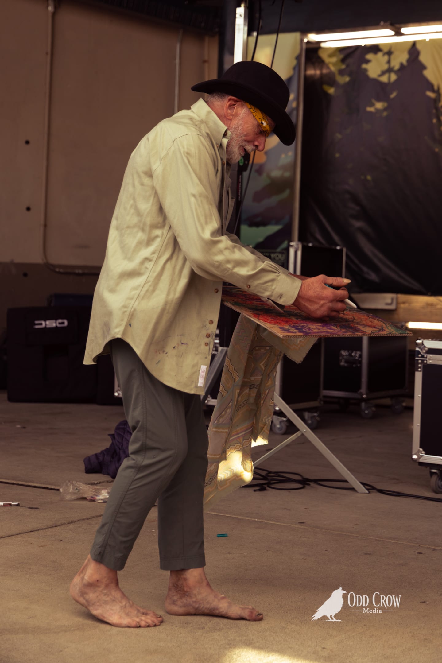 Regular pier attendee dancing and painting near the stage