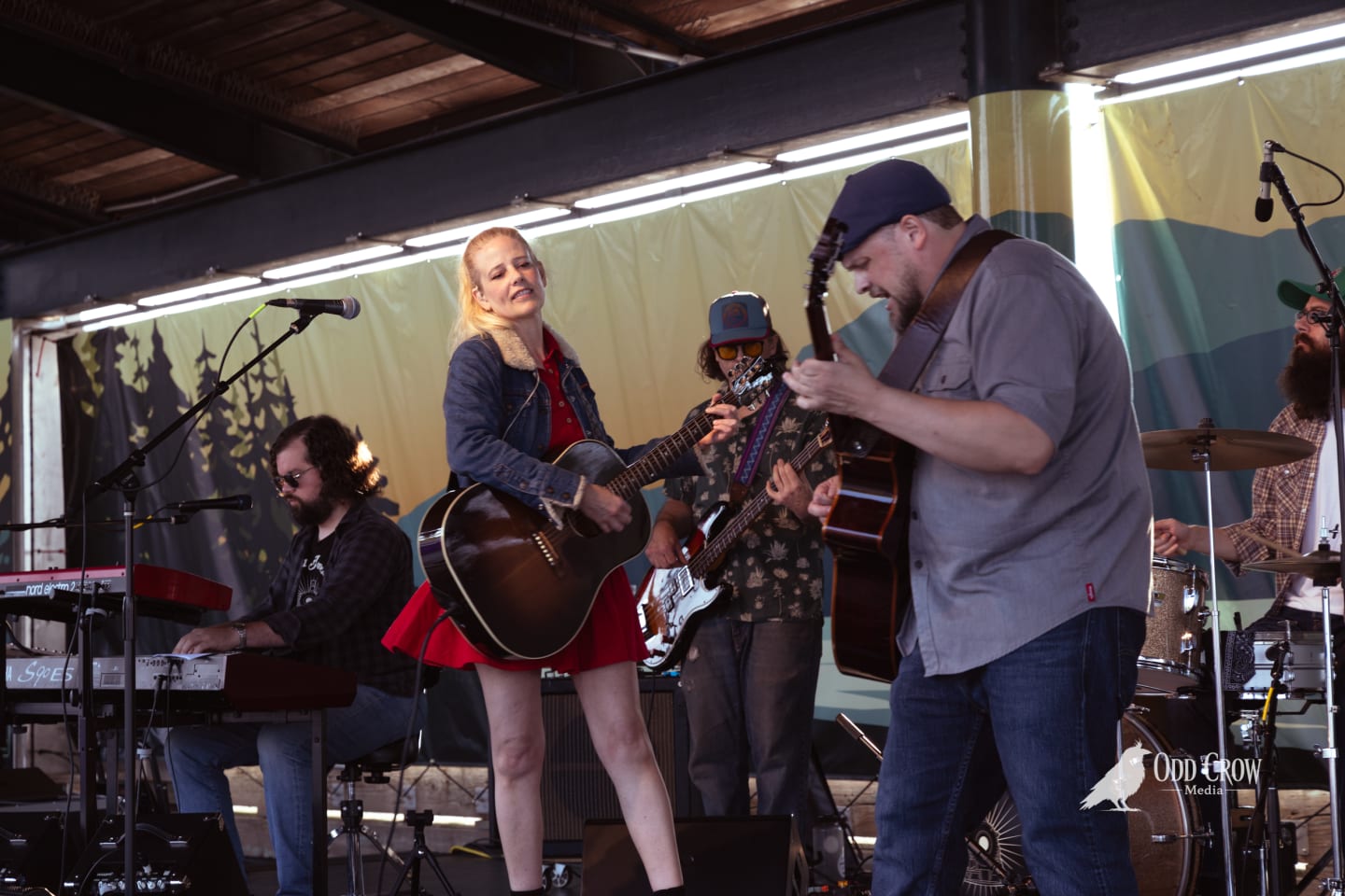 Band members performing together on the pier stage