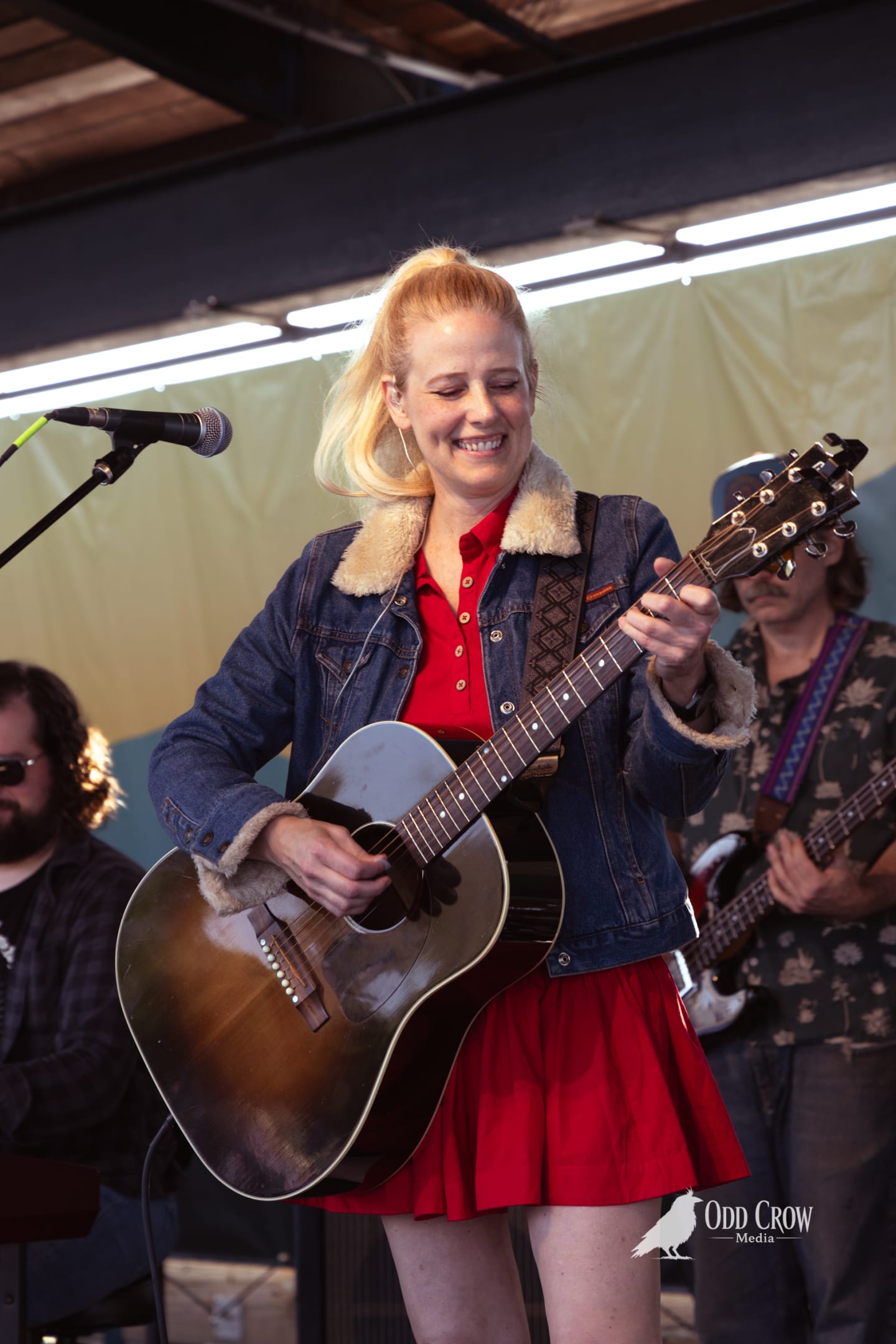 Lead singer in red dress performing at Concerts on the Pier