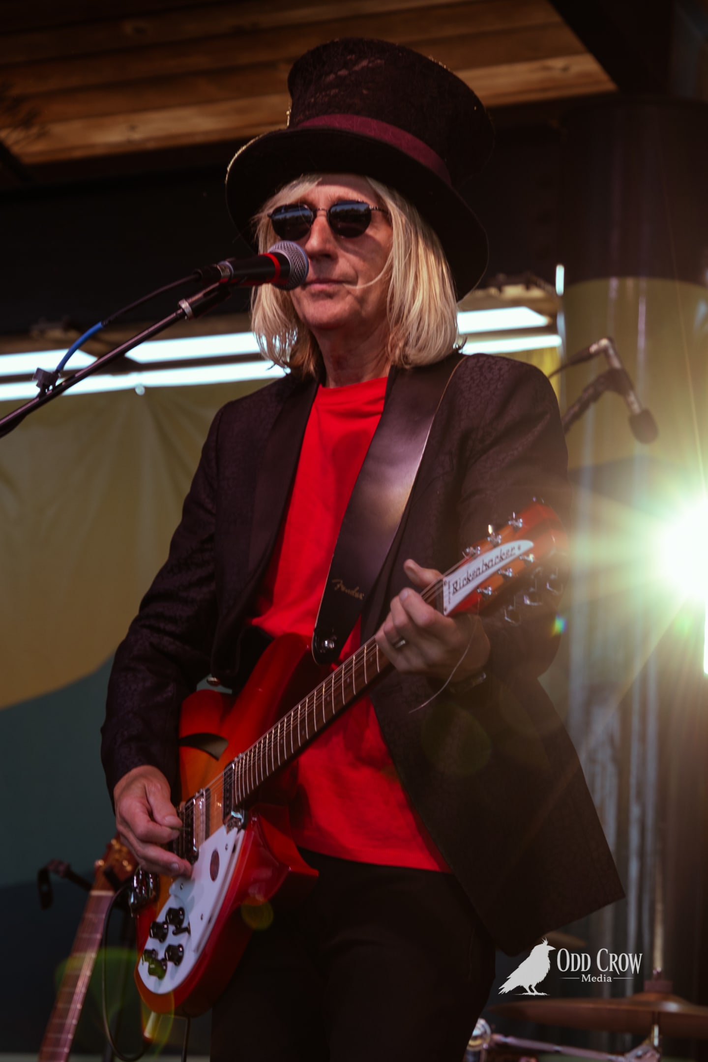 Petty Fever full band performing near the end of the set, singer in red shirt and top hat at center, three guitarists flanking him on stage