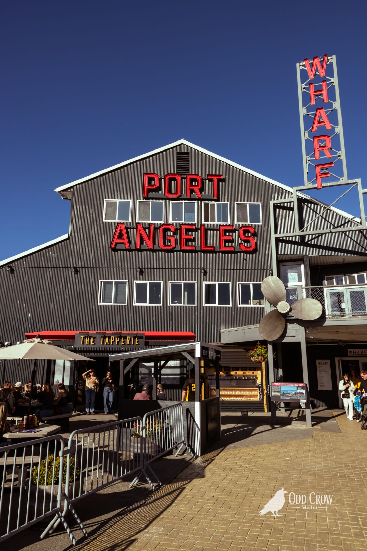 The Port Angeles Wharf building with its red PORT ANGELES sign against a clear blue sky