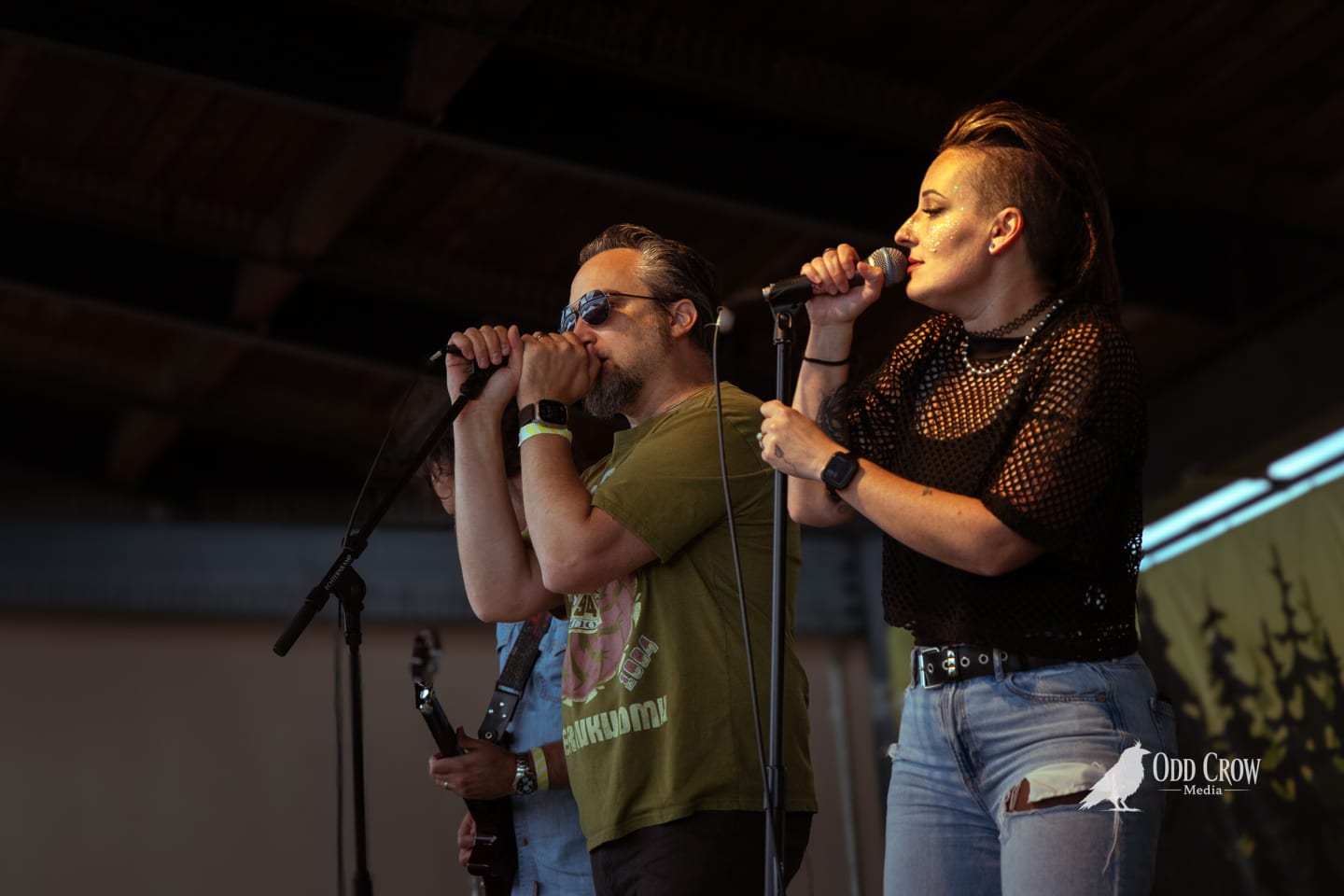 Male vocalist in a Soundgarden shirt and a female vocalist sharing the front of the stage