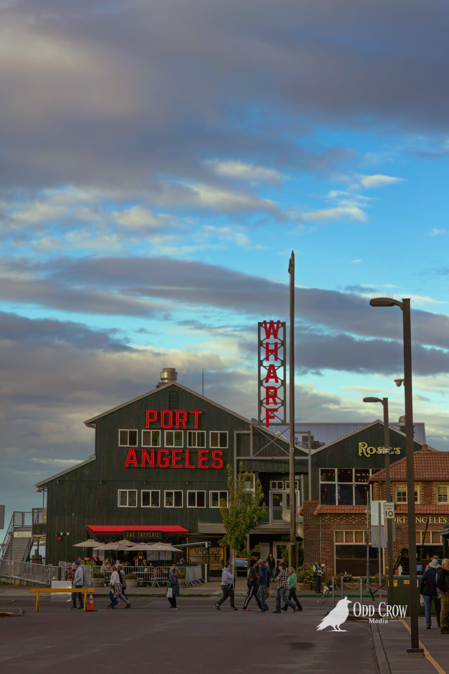 The Port Angeles Wharf building at dusk under soft blue and pink clouds