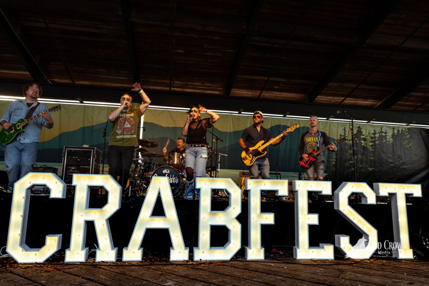 The band spread across the stage behind the lit CRABFEST marquee letters in warm evening light