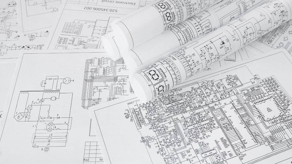 Engineers reviewing large-format technical drawings at a project table