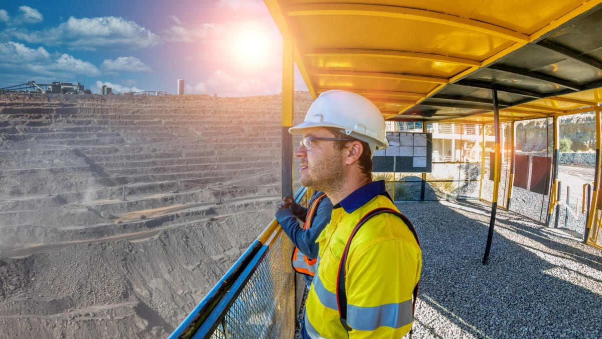 Field technician consulting engineering drawings in an industrial plant