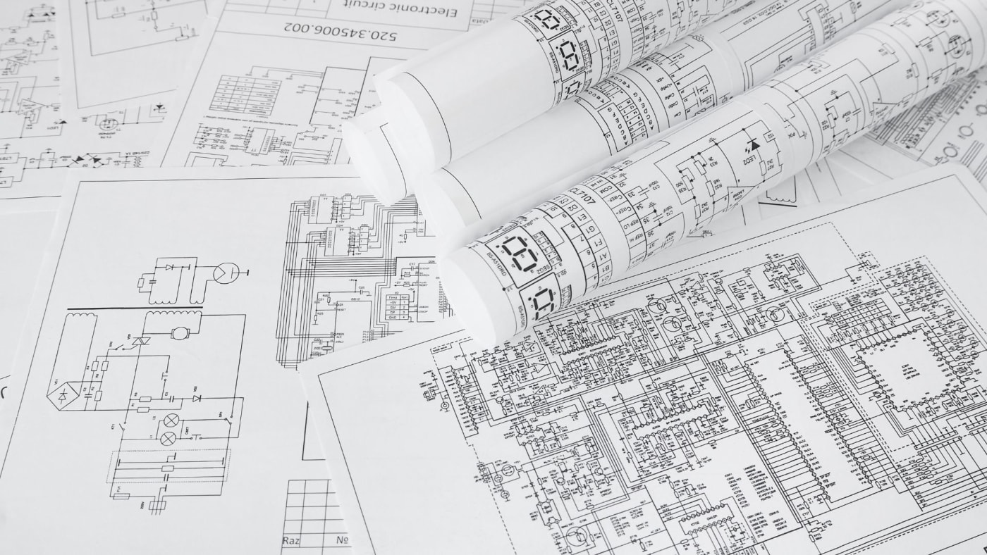 Engineers reviewing large-format technical drawings at a project table