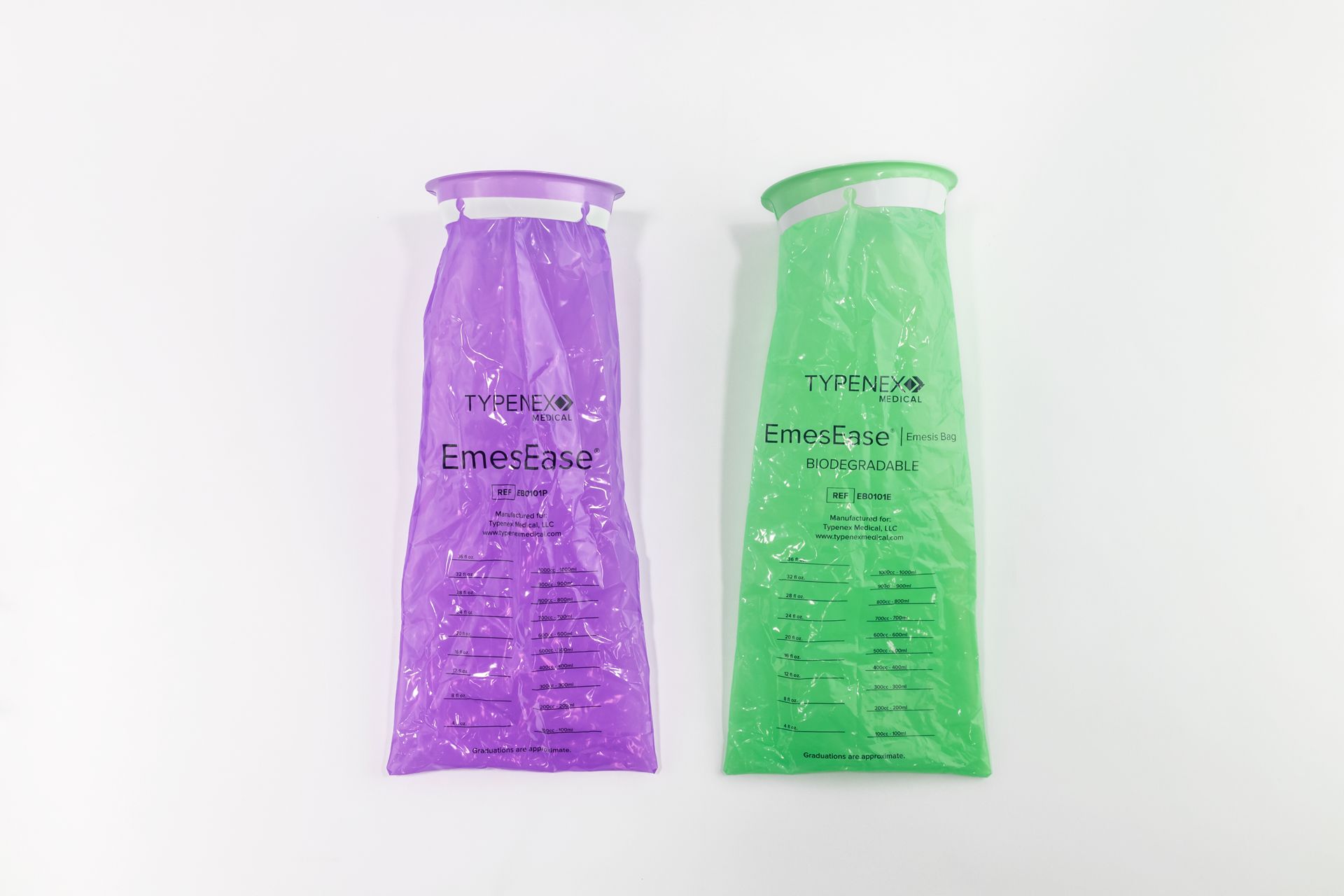 Left: Purple emesis bag with measurement graduations. Right: Green biodegradable emesis bag with measurement graduations.